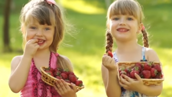 girls eating strawberries